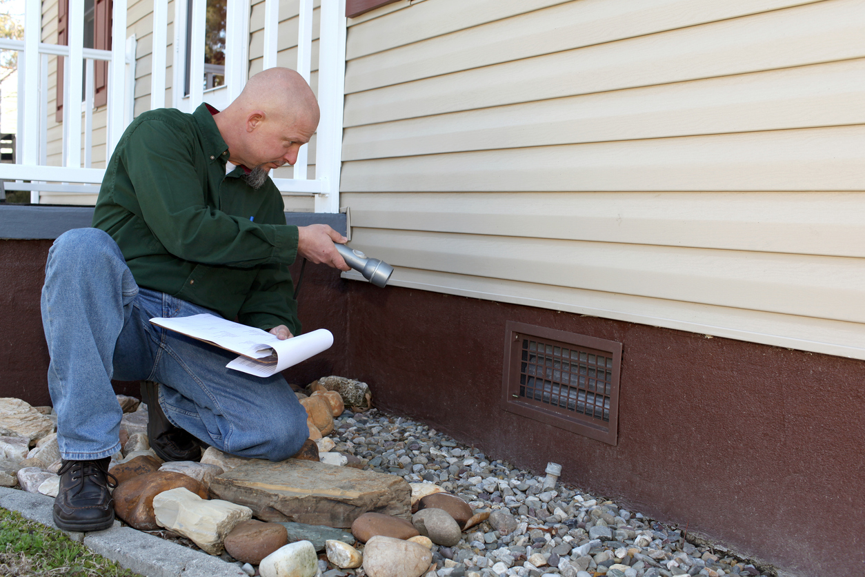 Foundation vent on the side of a home with a crawl space, ready to be covered for winter